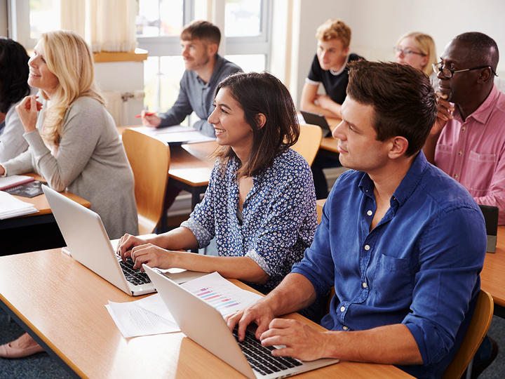 Mature Students Sitting at Desks